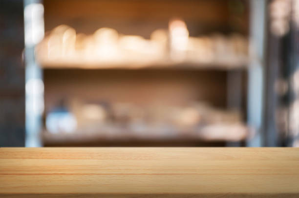 istock empty wooden desk over blurred interior decoration background 1129807901