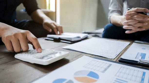 istock Business executives analyzing on valuation data paper with calculator 1129807905