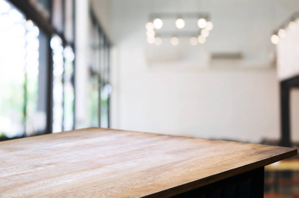 istock empty wooden table in front of blurred coffee shop cafe or workplace background 1129807907