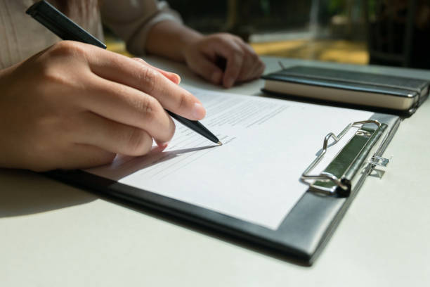 istock Hands of Woman Completing recruitment Application Form - job interview concept 1129807913