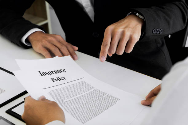 Insurance agent explain consulting with customer to signing the policy form. stock photo