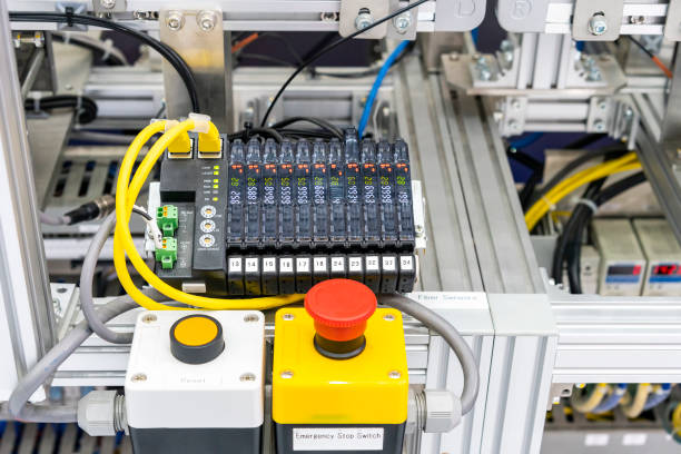 istock close up emergency stop switch and Ethernet sensor communication unit with fiber optic cable of high performance automatic manufacturing assembly and inspection process at production line 1129807947