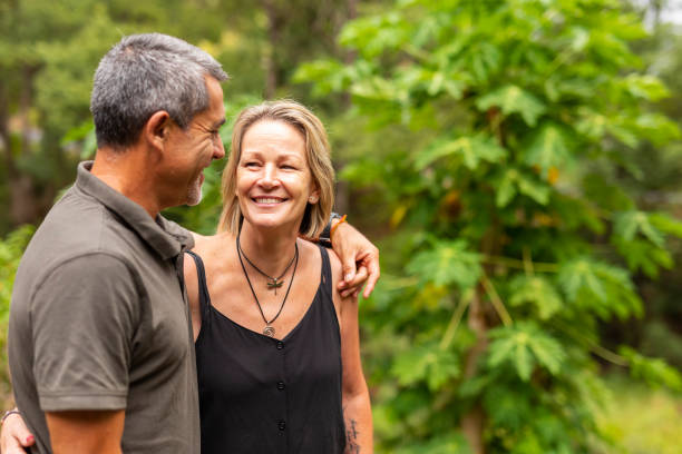 istock Happy Mature Couple Walking Together by a River 1129808062