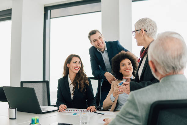 istock Young coworkers looking at senior management 1129809184
