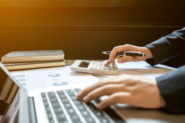 istock financial inspector  executive calculating on investment data with documents and laptop 1129810555