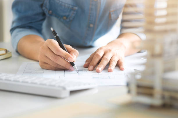 istock close up of young interior Architect working on blueprint with engineering tools 1129810571