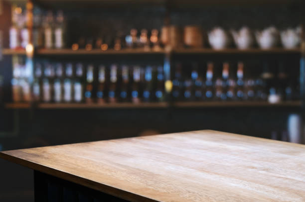 istock blank wooden table with blurred montage coffee shop cafe background 1129810762