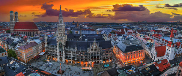 panoramic view over Munich with market square Marienplatz and cathedral Frauenkirche. Bavarian Capital in Germany with sights downtown at dawn with orange sunset munich cathedral photos stock pictures, royalty-free photos & images