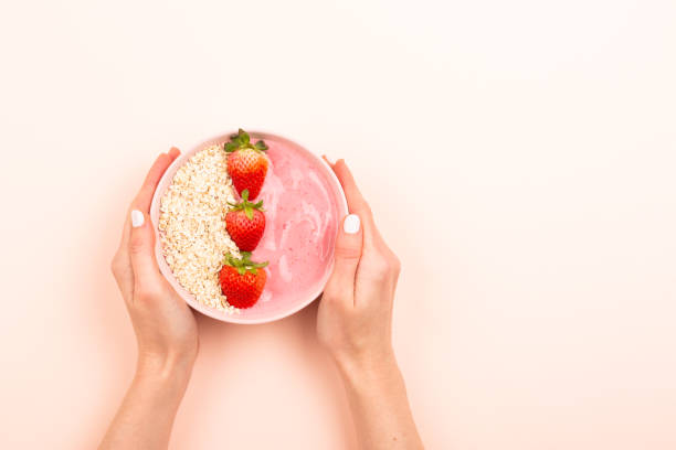 istock Smoothie bowl on pink background 1129812467