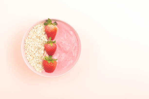 istock Smoothie bowl on yellow background 1129812503
