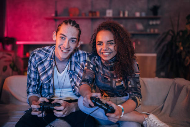 istock Couple playing video games at home 1129812858