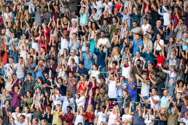 istock Group of spectators cheering in stadium 1129815985