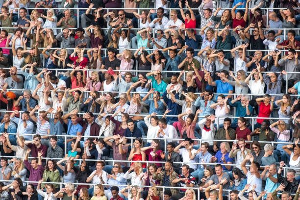 istock Group of spectators cheering in stadium 1129815987