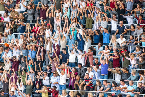 istock Group of spectators cheering in stadium 1129815989