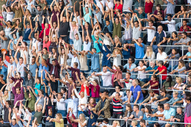 istock Group of spectators cheering in stadium 1129815990