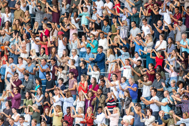 istock Group of spectators cheering in stadium 1129815991