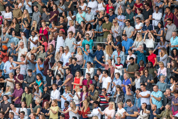 istock Group of spectators cheering in stadium 1129815992