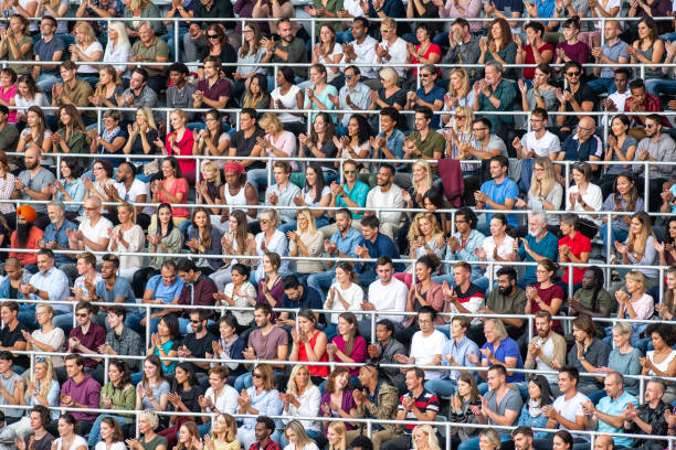 istock Group of spectators cheering in stadium 1129815994