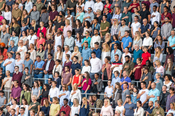 istock Group of spectators singing national anthem in stadium 1129815995