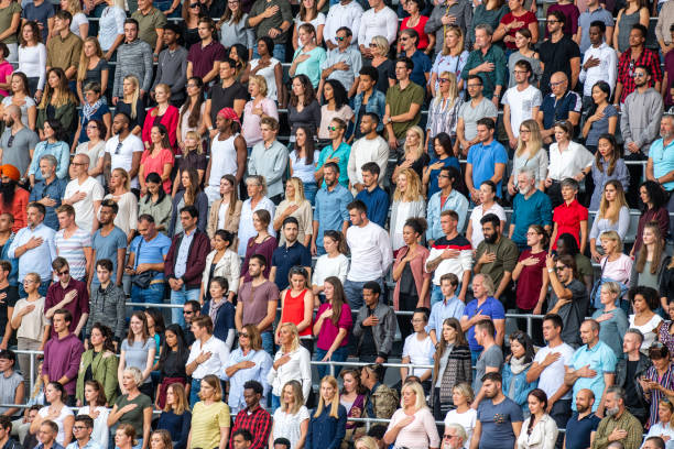 istock Group of spectators singing national anthem in stadium 1129815997