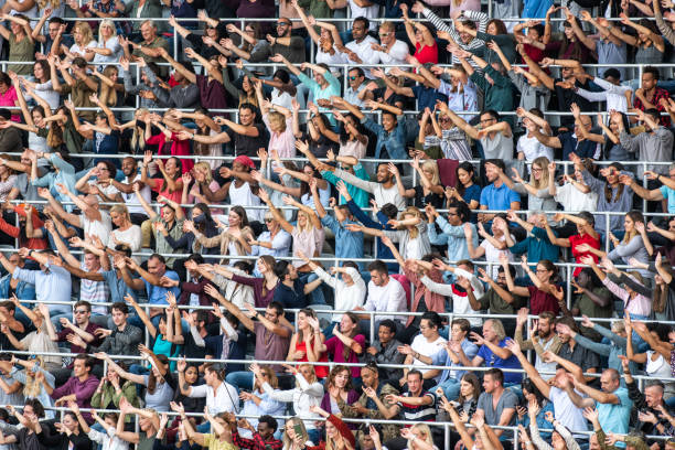 istock Group of spectators cheering in stadium 1129815998