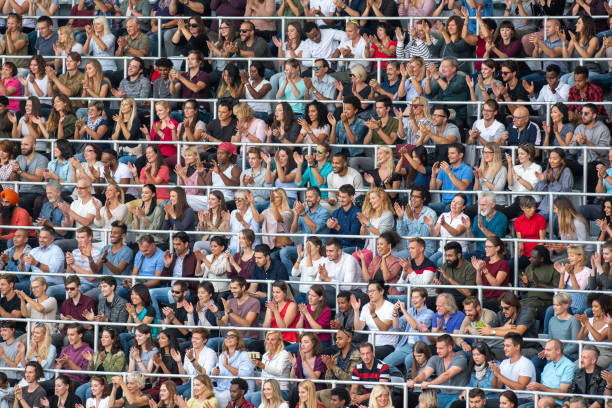 istock Group of spectators cheering in stadium 1129815999