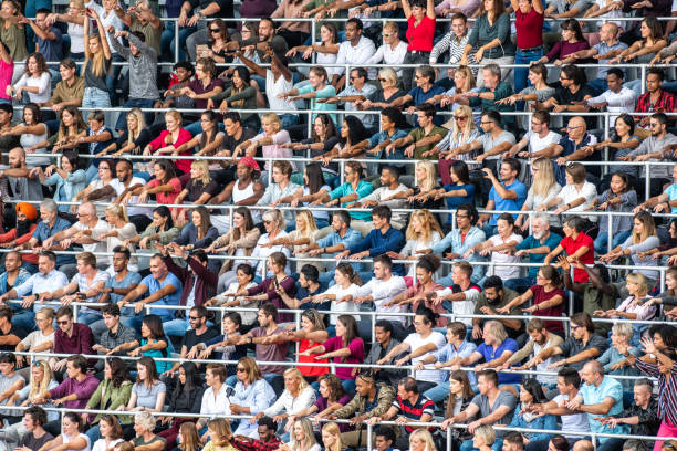 istock Group of spectators cheering in stadium 1129816000
