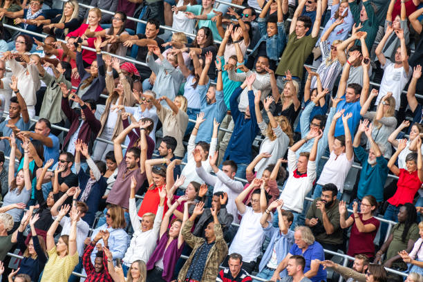 istock Group of spectators cheering in stadium 1129816001