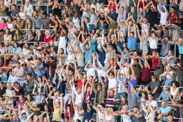istock Group of spectators cheering in stadium 1129816002