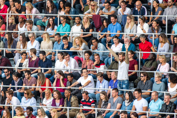 istock Group of spectators cheering in stadium 1129816007