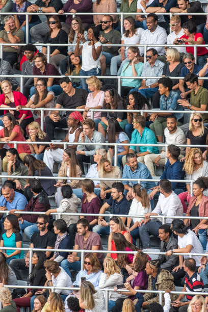 istock Group of spectators cheering in stadium 1129816012