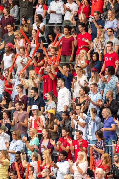 istock Group of spectators cheering in stadium 1129816078