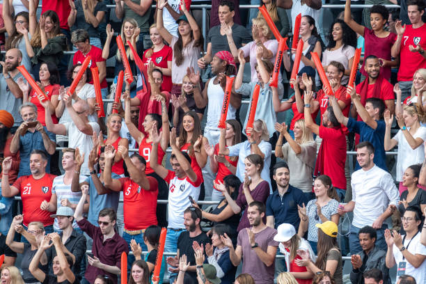 istock Group of spectators cheering in stadium 1129816080