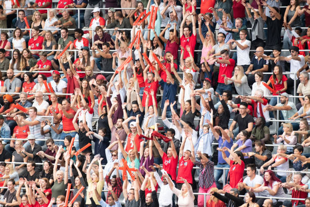 Football fans clapping on the podium of the stadium