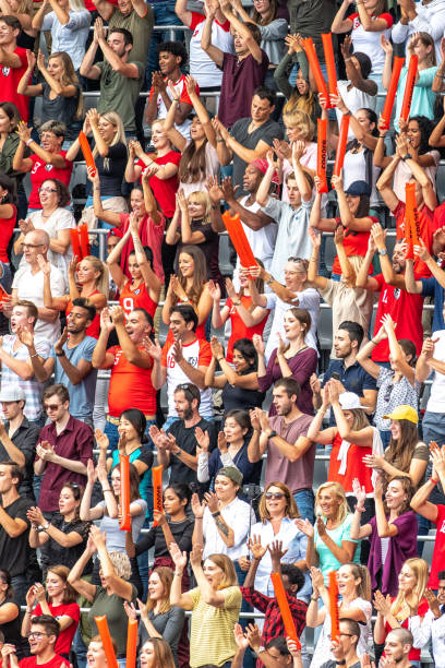 istock Group of spectators cheering in stadium 1129816090