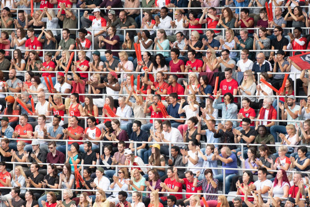 istock Group of spectators cheering in stadium 1129816097