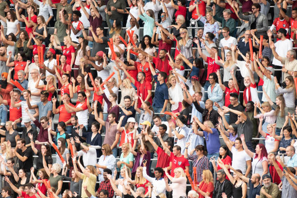istock Group of spectators cheering in stadium 1129816100