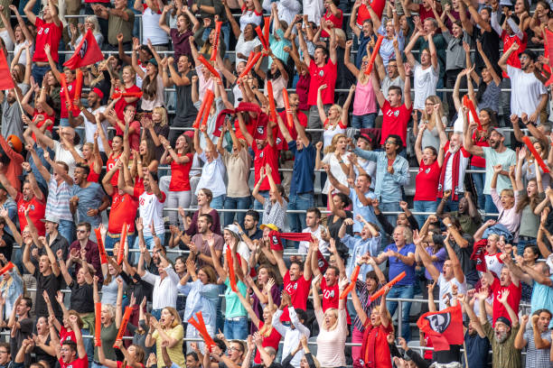 istock Group of spectators cheering in stadium 1129816107