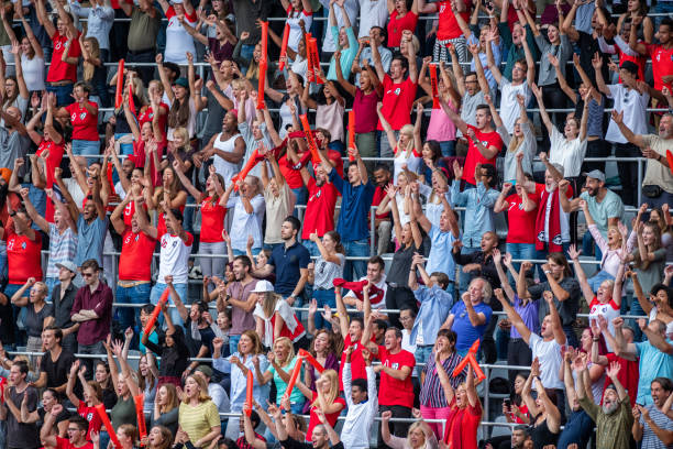 istock Group of spectators cheering in stadium 1129816108