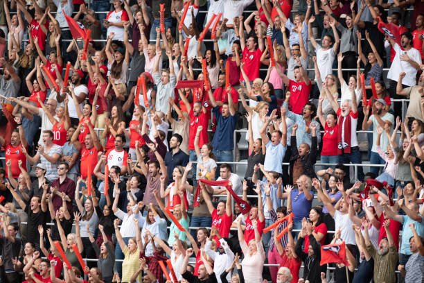 istock Group of spectators cheering in stadium 1129816110