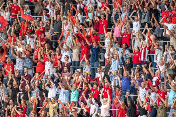 istock Group of spectators cheering in stadium 1129816113