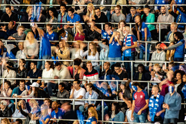 istock Group of spectators cheering in stadium 1129816122