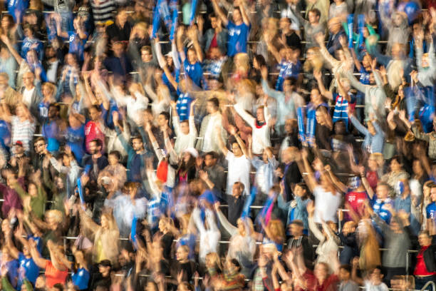 istock Group of spectators cheering in stadium 1129816124