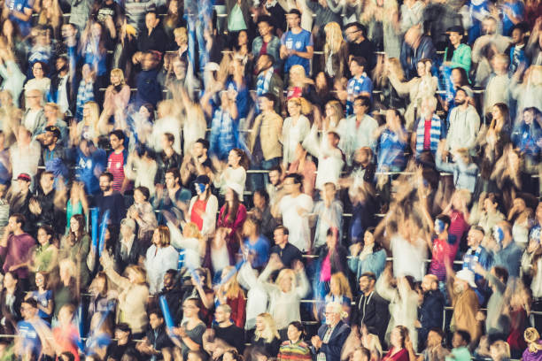 istock Group of spectators cheering in stadium 1129816135