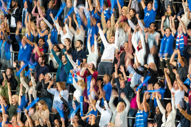 istock Group of spectators cheering in stadium 1129816136