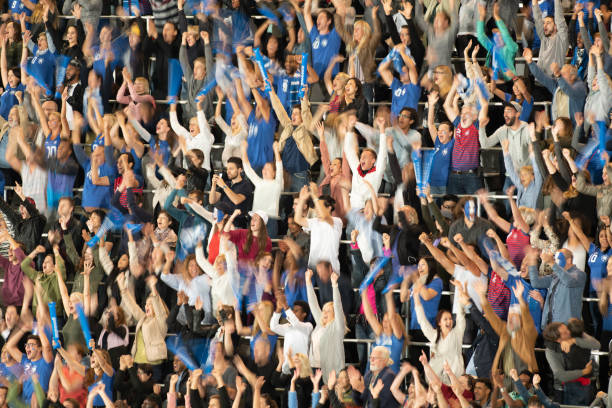 istock Group of spectators cheering in stadium 1129816137