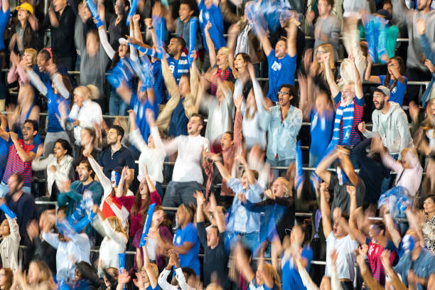 istock Group of spectators cheering in stadium 1129816138