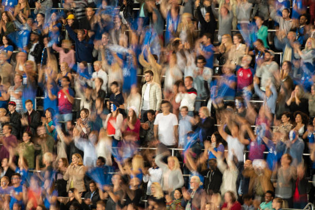 istock Group of spectators cheering in stadium 1129816140