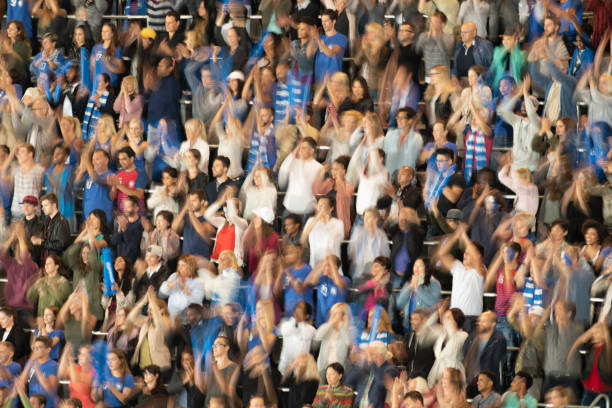 istock Group of spectators cheering in stadium 1129816142
