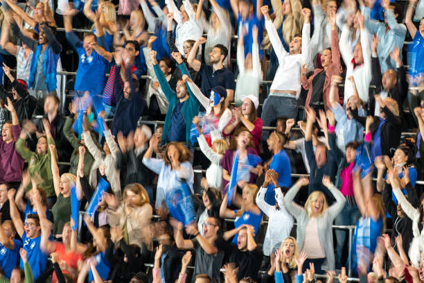 istock Group of spectators cheering in stadium 1129816143